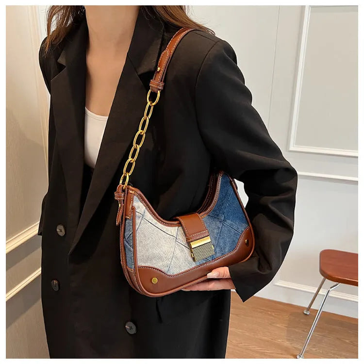 Brown denim women's bucket shoulder bag with diamond mesh detail and a chain strap.