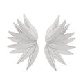 Gold and white alloy leaf shape patch earrings on a flat surface