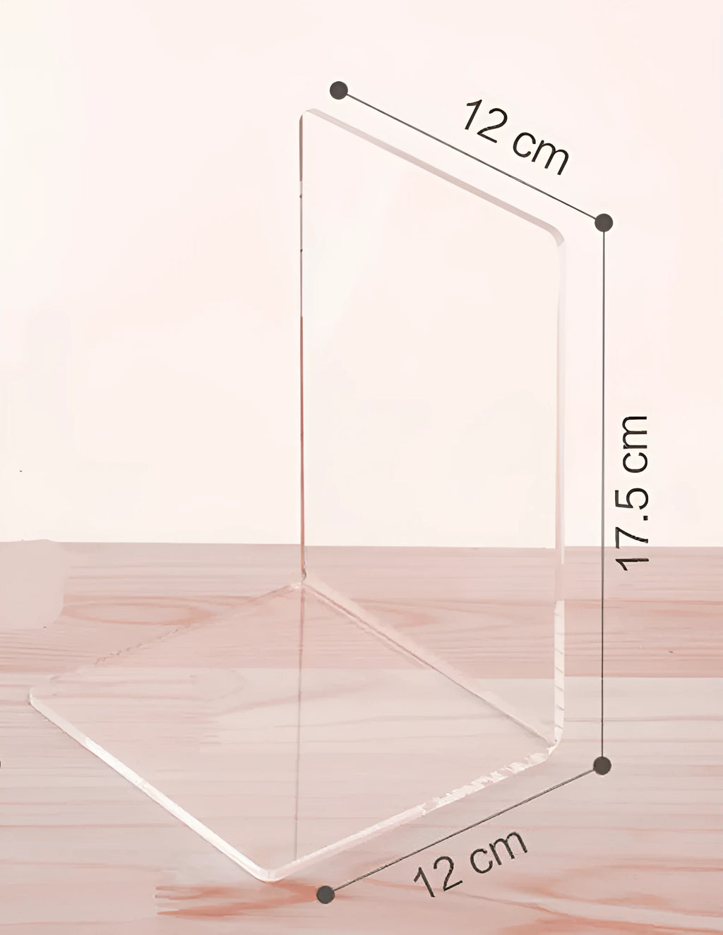 Transparent acrylic bookshelf displaying books in organised pairs on a desk