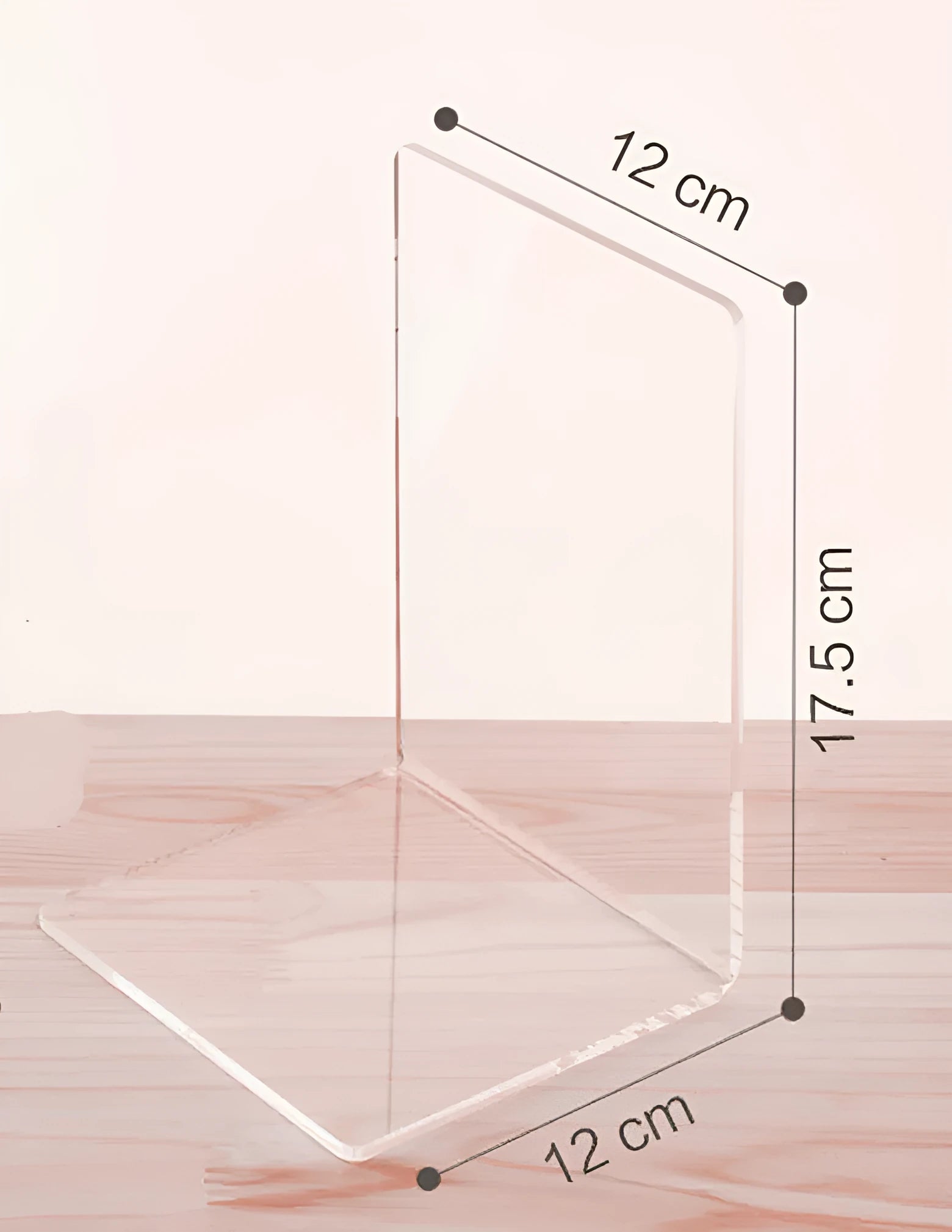 Transparent acrylic bookshelf displaying books in organised pairs on a desk