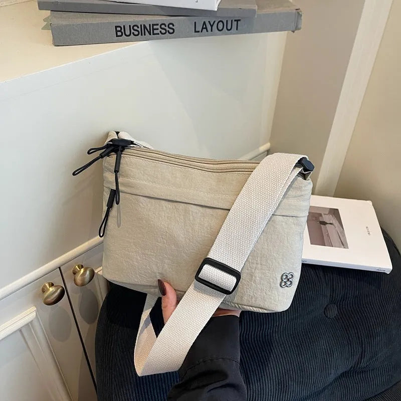 Soft cloth daily lightweight commuter crossbody bag in beige with sandwich pocket and sewn-thread detailing