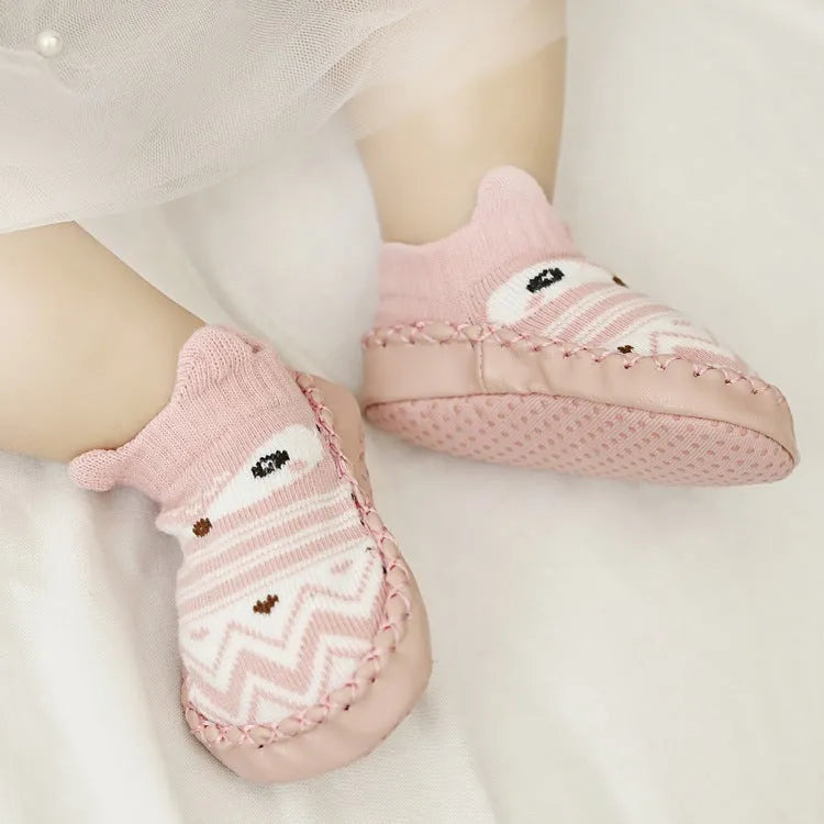 Pair of pastel coloured baby socks with anti-slip dots on the sole, shown flat.