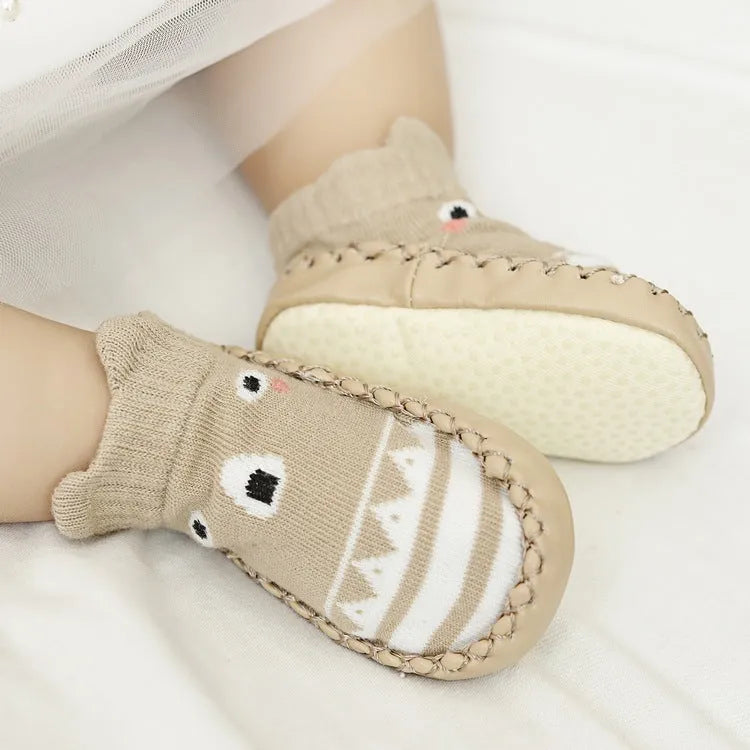 Pair of pastel coloured baby socks with anti-slip dots on the sole, shown flat.