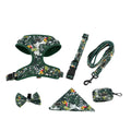 Six-piece adjustable dog harness set with leash, collar, waste bag, bow, and scarf on a blue background.