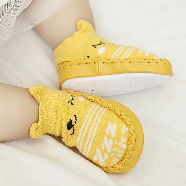 Pair of pastel coloured baby socks with anti-slip dots on the sole, shown flat.