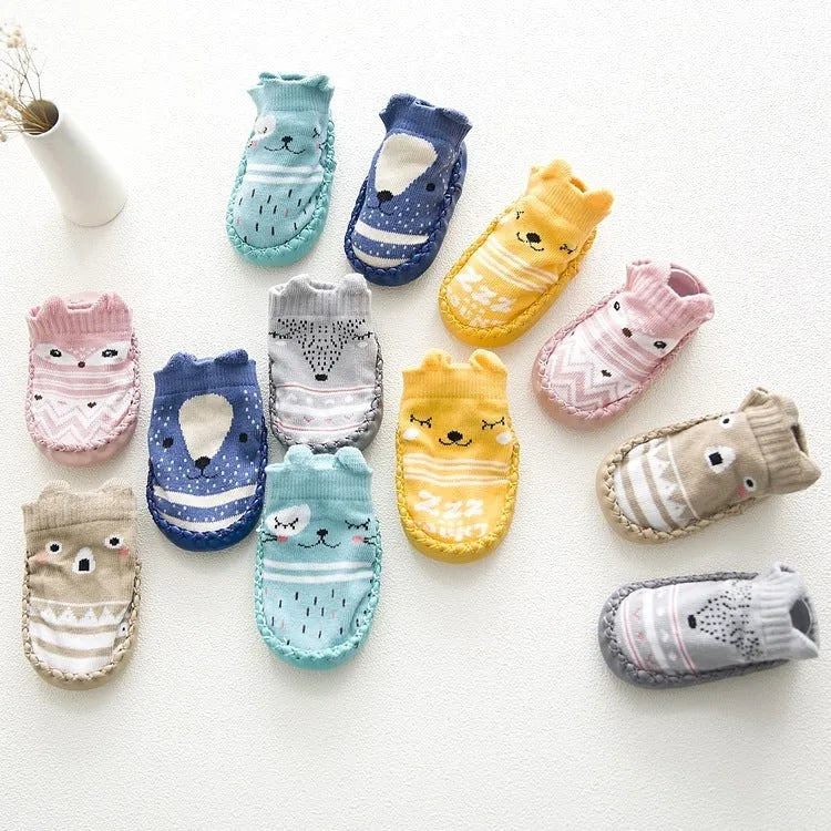 Pair of pastel coloured baby socks with anti-slip dots on the sole, shown flat.
