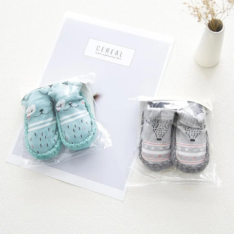 Pair of pastel coloured baby socks with anti-slip dots on the sole, shown flat.