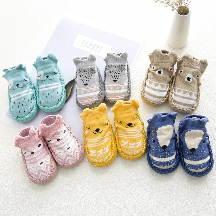Pair of pastel coloured baby socks with anti-slip dots on the sole, shown flat.