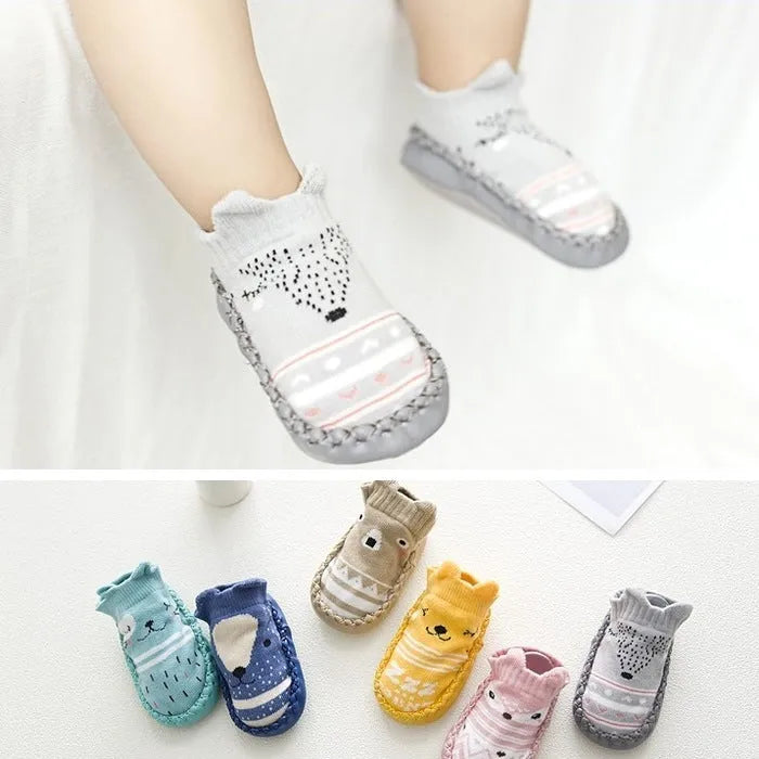 Pair of pastel coloured baby socks with anti-slip dots on the sole, shown flat.