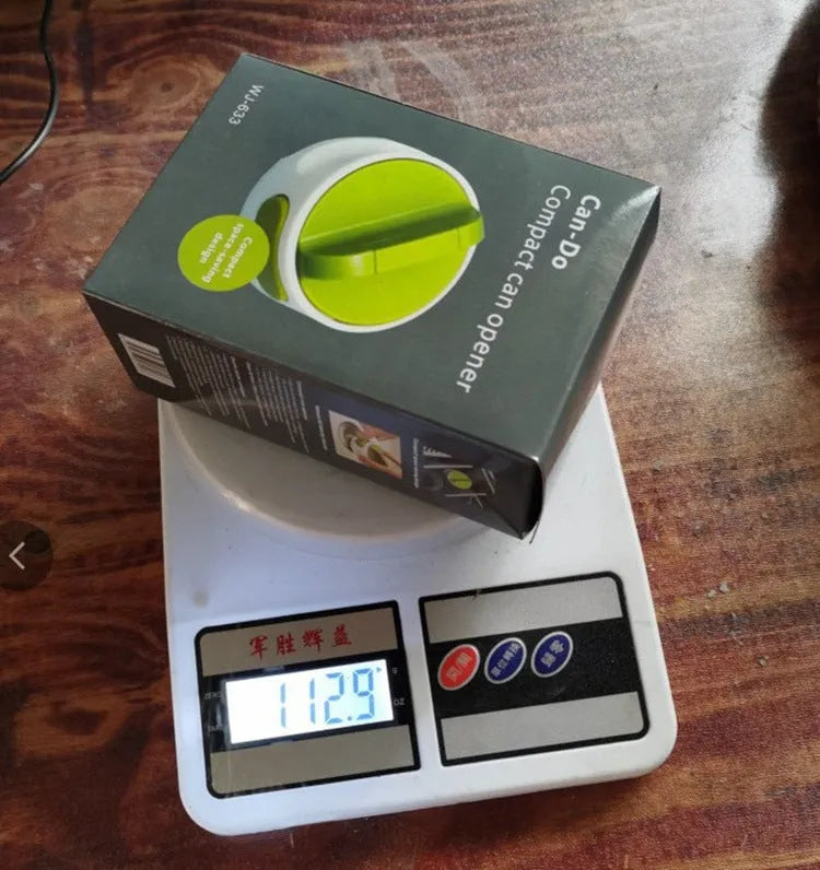 A green stainless steel manual bottle opener and lid removal tool on a kitchen counter.