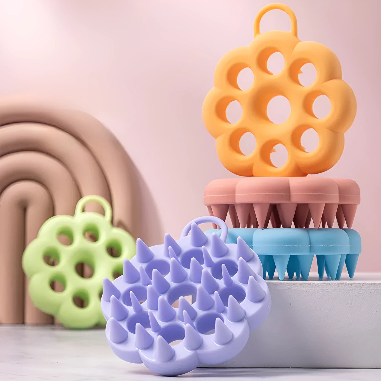 Handheld silicone pet grooming brush for wet and dry use, shown in assorted colours.