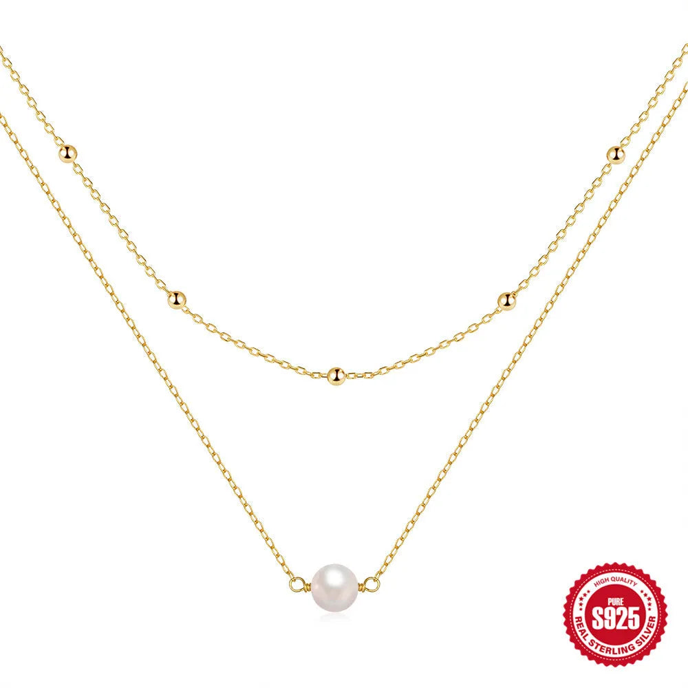 Sterling silver geometric pendant necklace with two pearls, on a ball bead chain, shown in gold and white gold plating.