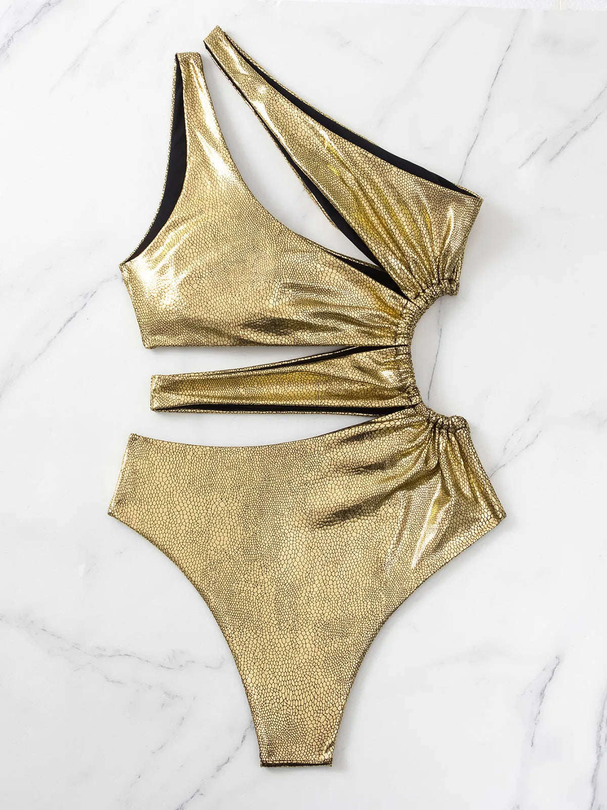 Gold women's one-piece swimsuit with backless design and spandex construction