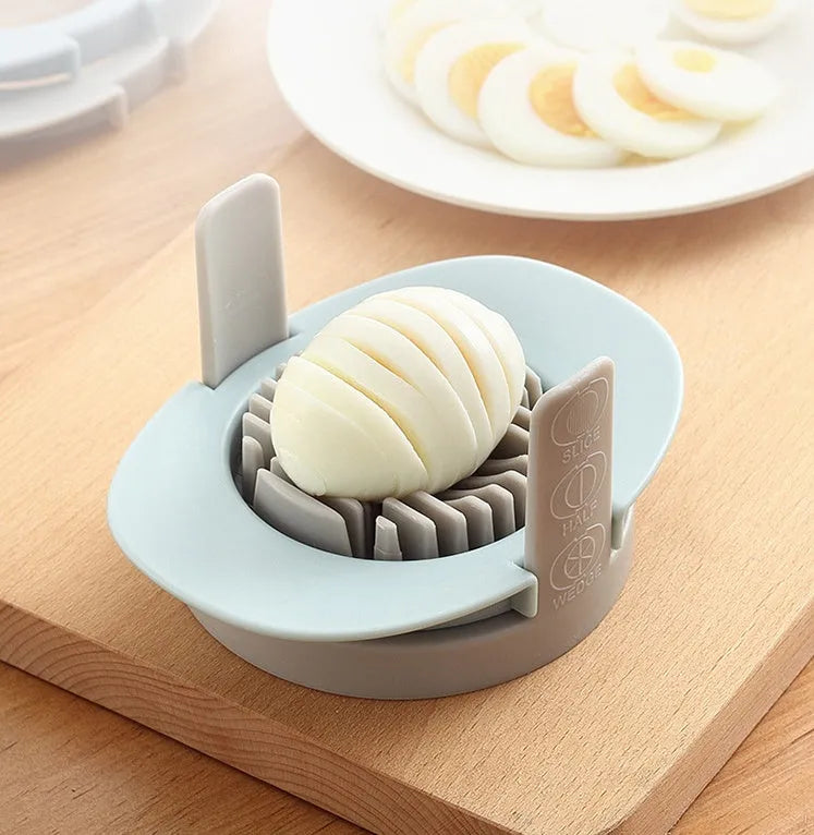 Manual three-in-one egg cutter in blue, orange and red with stainless steel blades and stackable design