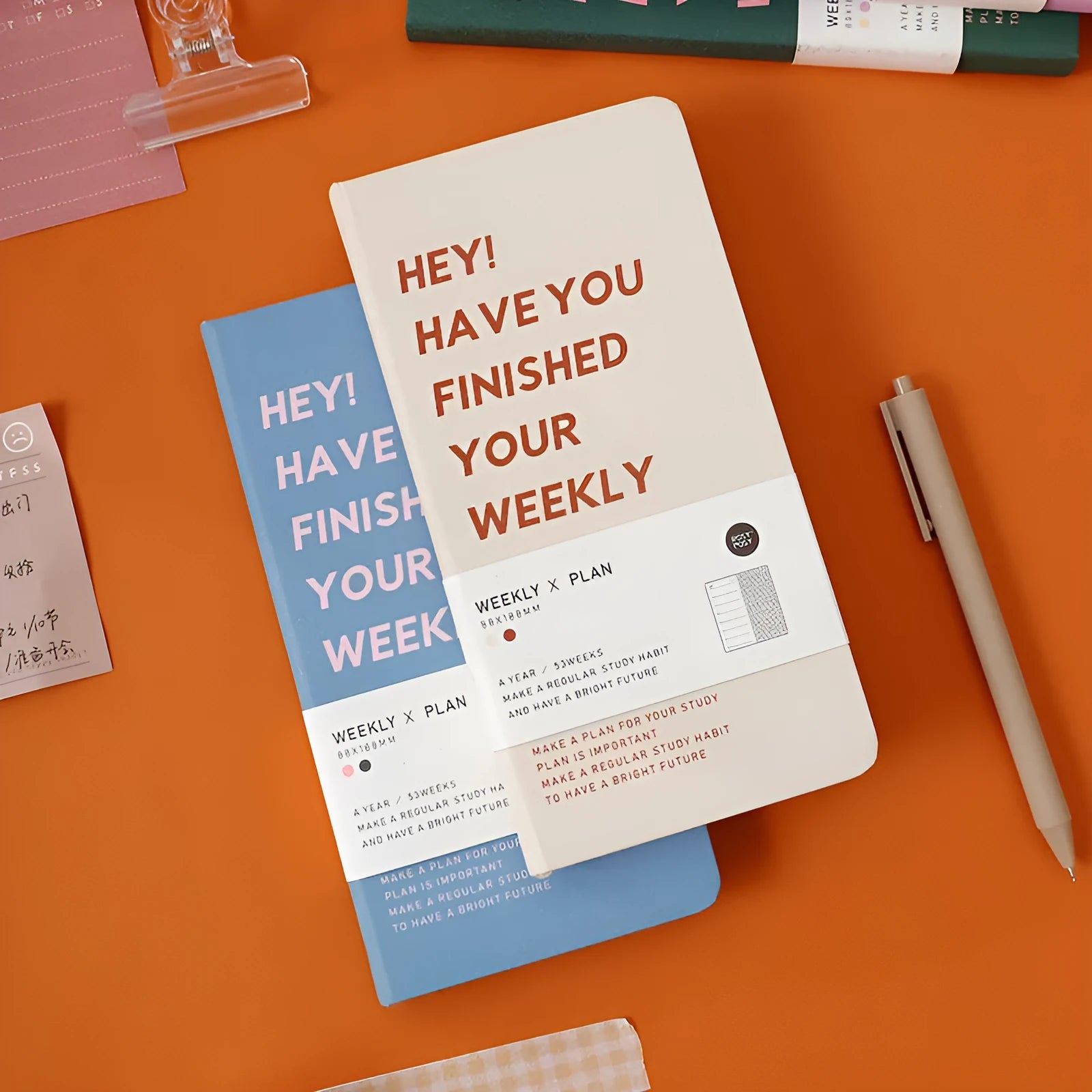 Weekly plan diary handbook showing four colour options: blue, brown, green, and purple