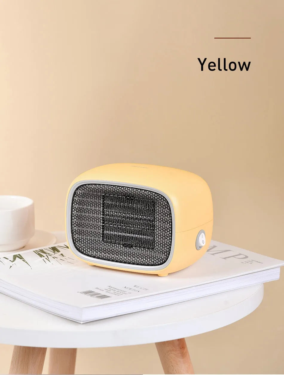 Compact green mini ceramic heater on a desktop showing its small size and EU plug.
