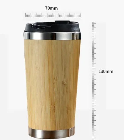 Bamboo travel coffee cup with stainless steel interior, leak-proof lid, and a grey foam pad.