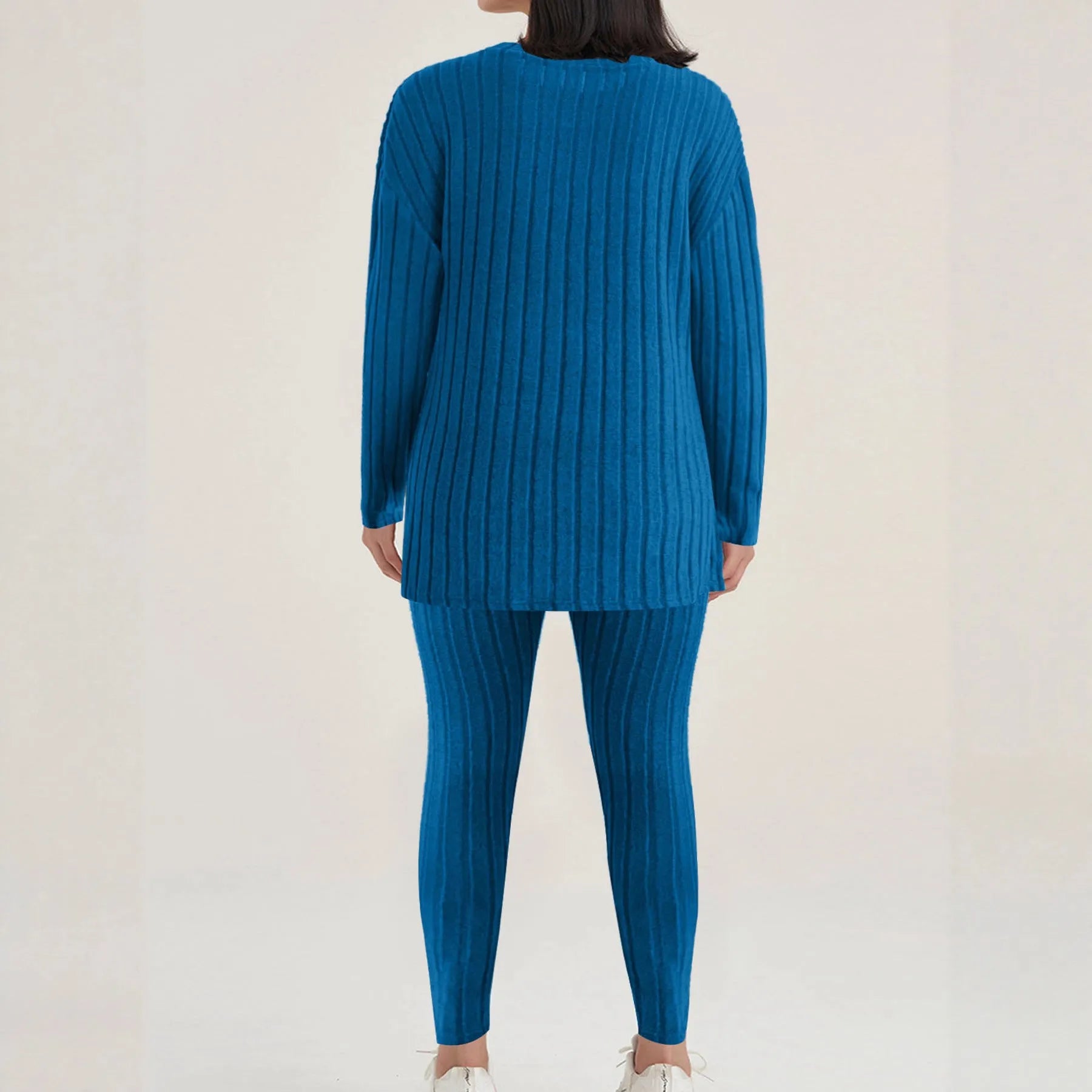 Black sunken stripe two-piece loungewear set with top and trousers on a hanger.