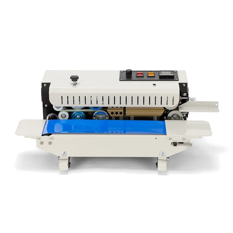 Compact manual sealing machine with date stamp on steel head, placed on a kitchen worktop.