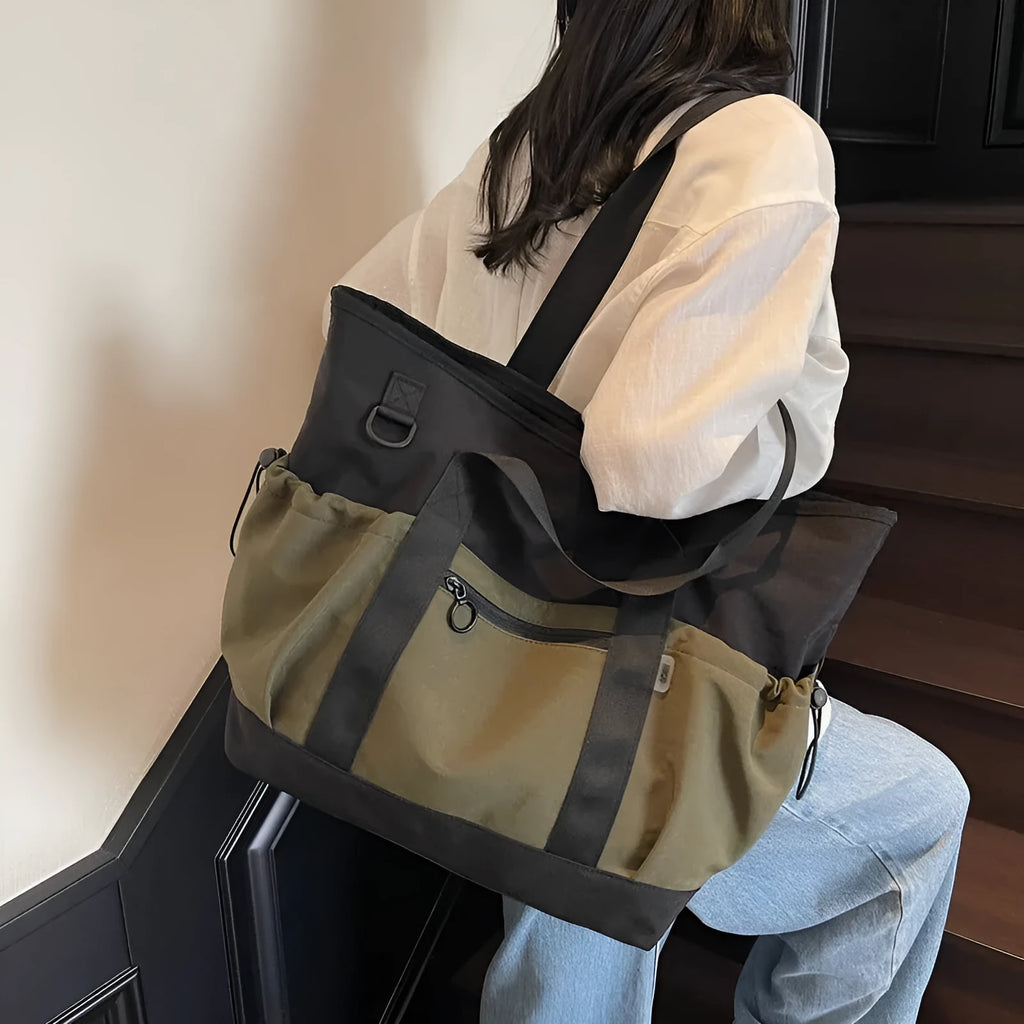 Lightweight Oxford cloth duffel bag for women in grey, shown with a yoga mat.