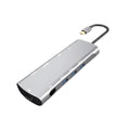 Grey aluminium USB-C docking station with multiple ports including HDMI, VGA, and USB, showing its 140mm attached cable.