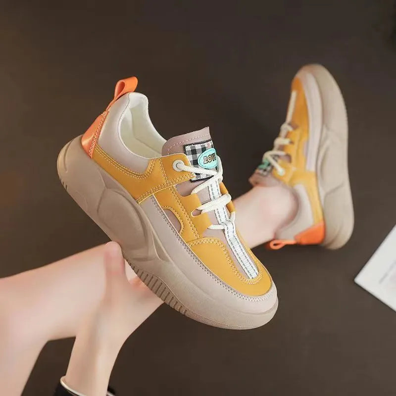Women's beige thick-sole stitching sneakers with round toe and front lacing on a white background