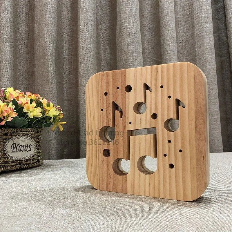 Wooden cube LED atmosphere lamp with warm white light on a desk, showing USB cable.
