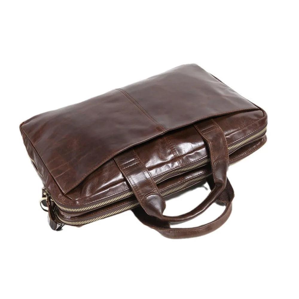 Brown leather men's business briefcase with laptop compartment showing cowhide texture
