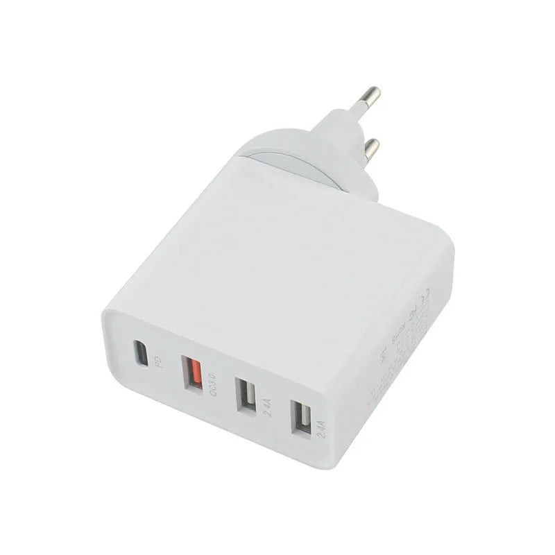 Black 48W USB-C four-port fast wall charger with UK plug on a wooden surface