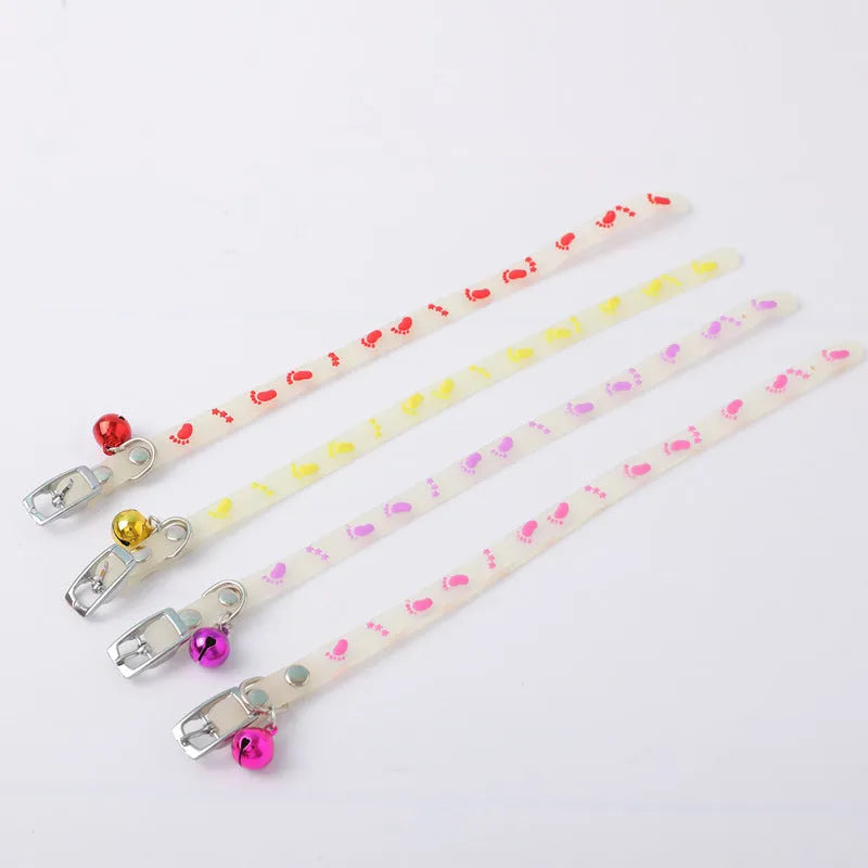 Luminous cat collar with glowing effect, silicone chain, metal bell, in a paw print pattern design.
