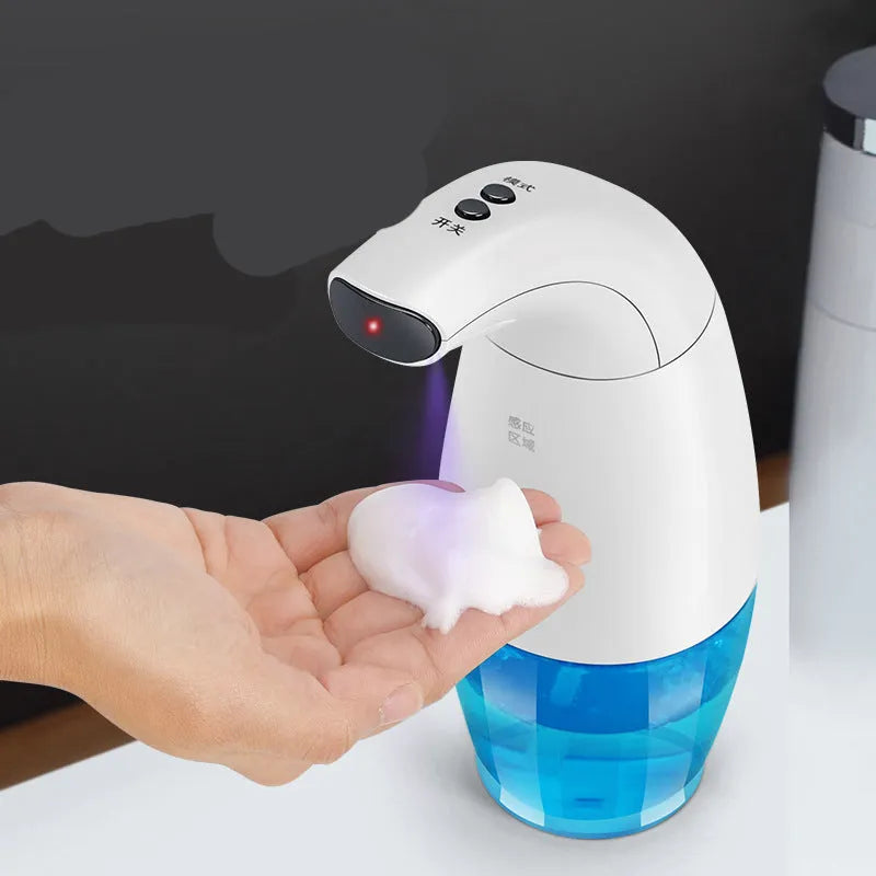 White intelligent induction foam machine on countertop with hand under nozzle dispensing foam