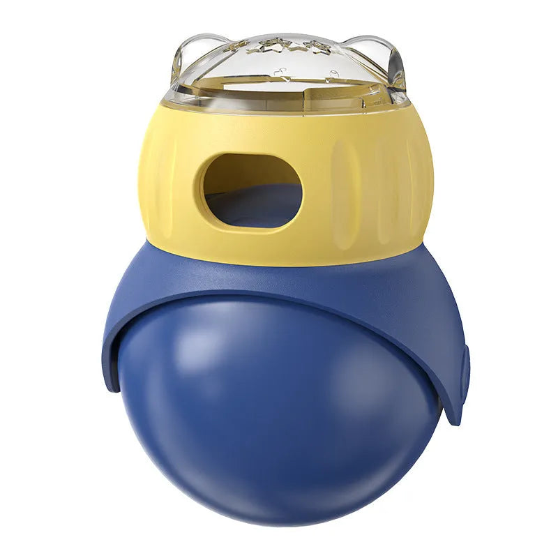 Yellow and blue Tumbler Owl interactive cat feeder toy on a wooden floor