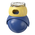 Yellow and blue Tumbler Owl interactive cat feeder toy on a wooden floor