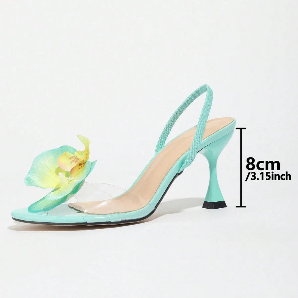 Green women's stiletto sandals with a high heel, round toe, and a 3D flower detail on the back strap.