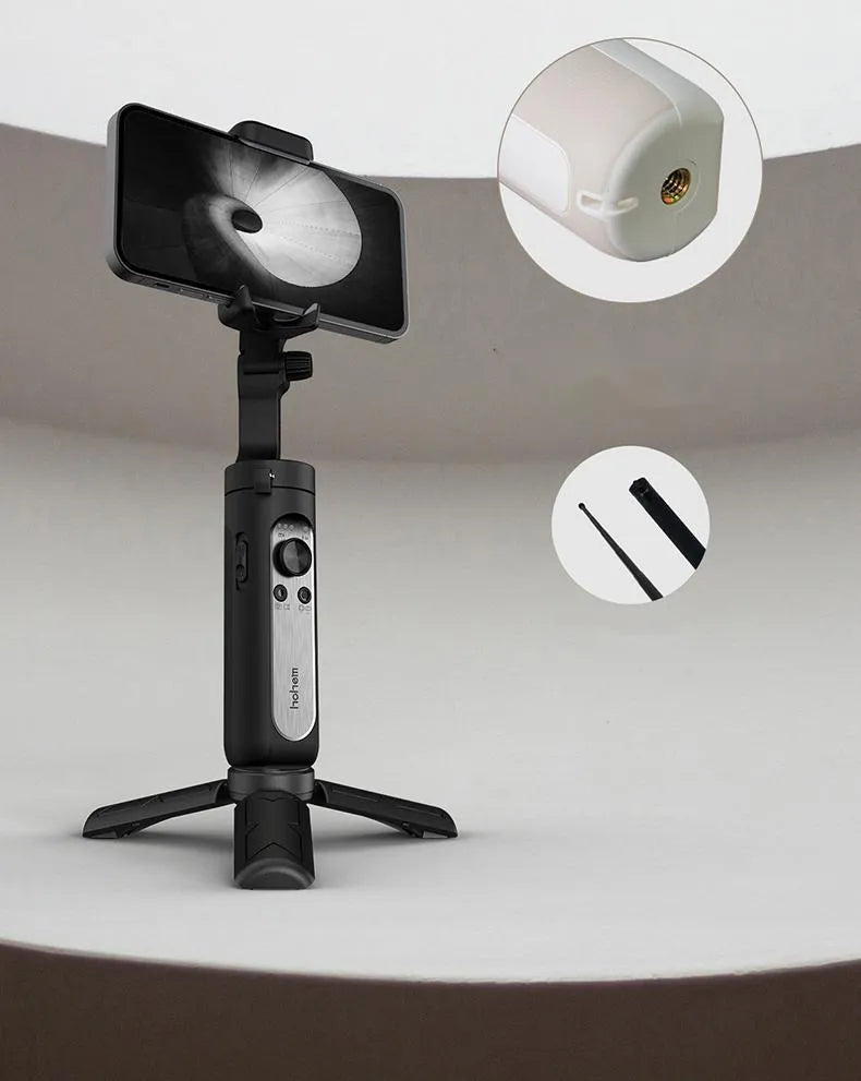 Black 3-axis mobile phone stabilizer gimbal shown in folded position next to a selfie stick.