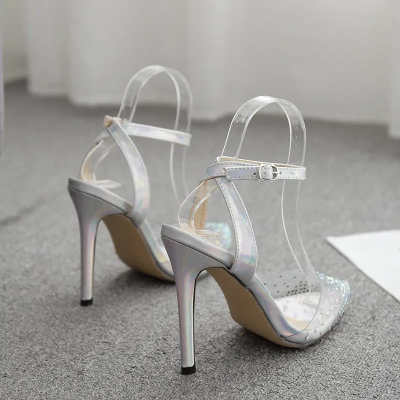 Women's pointed-toe PVC sandals with a stiletto heel on a plain background.