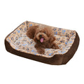 Beige sofa-style plush pet bed for small dogs with raised basket edges on a wooden floor.