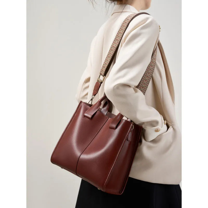 Women's genuine leather shoulder tote bag in black colour showing bucket design and polyester lining
