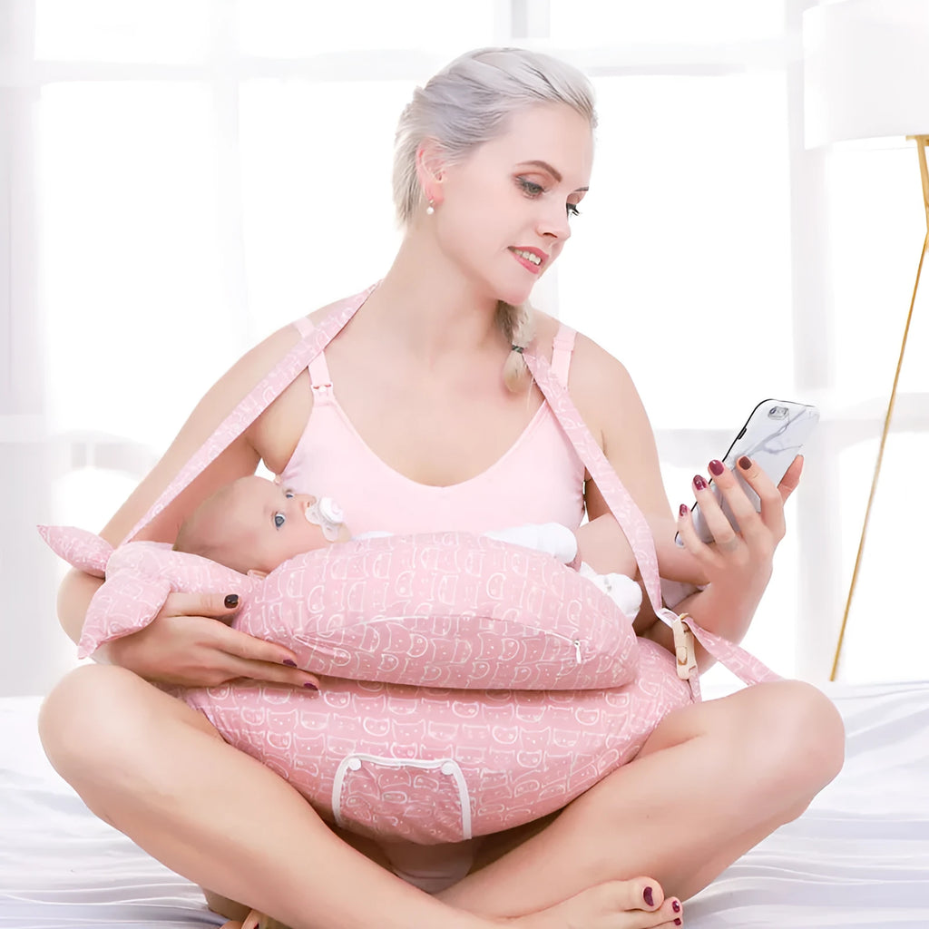 Multifunction nursing pillow with adjustable strap and white cotton cover for breastfeeding and baby support.