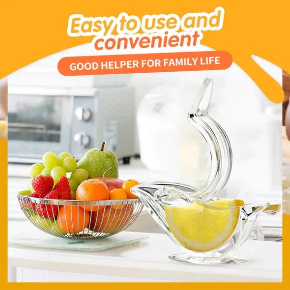 Transparent acrylic bird-shaped manual lemon juicer on a kitchen counter.