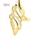 Women's exaggerated curve fashion ring in Q611 gold colour, made from copper with sparkling zircon stone accents.