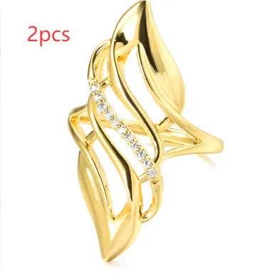 Women's exaggerated curve fashion ring in Q611 gold colour, made from copper with sparkling zircon stone accents.