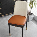 Leather horseshoe-shaped seat cushion on a chair, shown in a solid colour with a non-slip base.