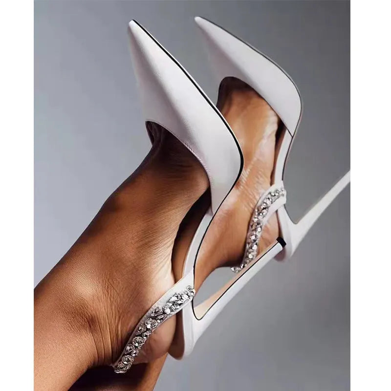 Women's black patent leather pointed toe high heel sandals with rhinestone decoration on the side.