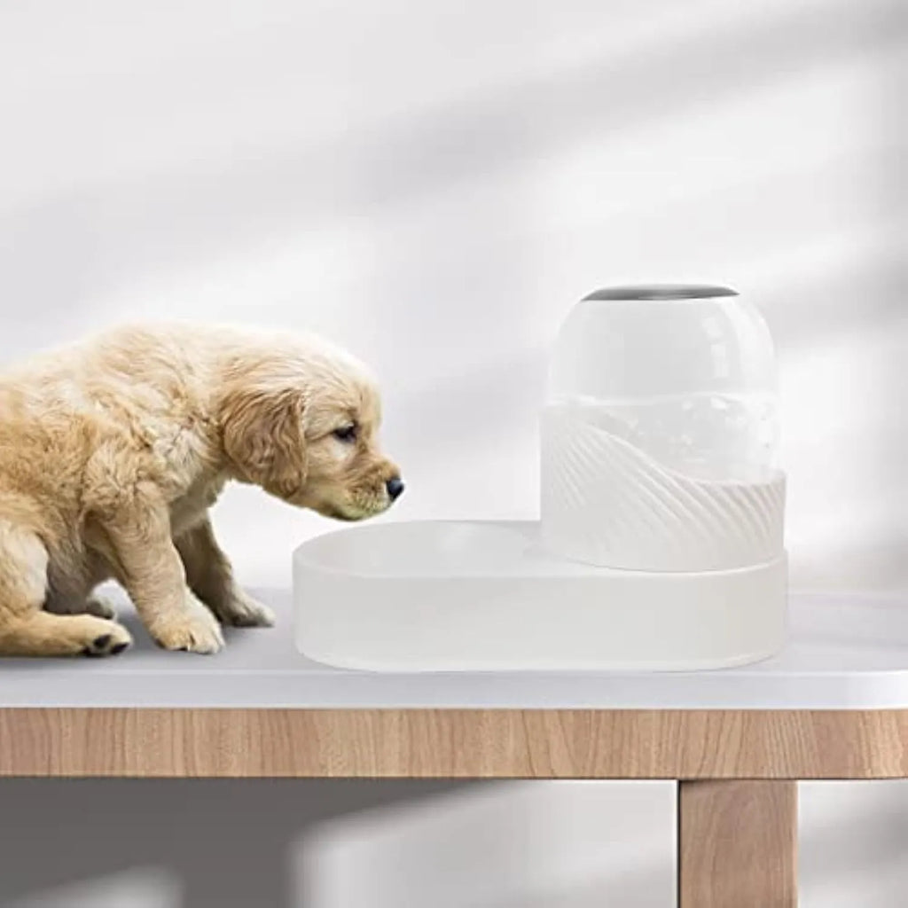 White automatic gravity cat feeder and water dispenser set with wave-shaped design on a table.