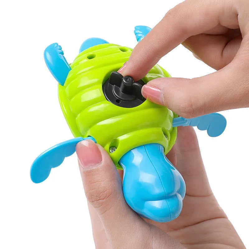 Small green plastic swimming turtle bath toy floating in water