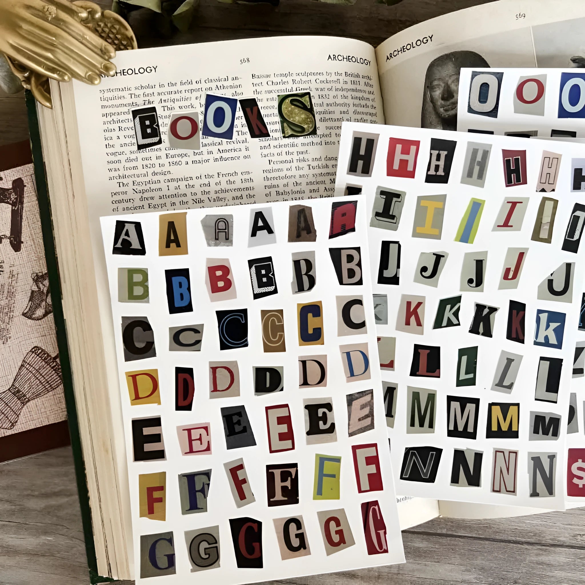 Pack of printed decorative stickers showing English letters, numbers, symbols, and weekly words in a cute style.
