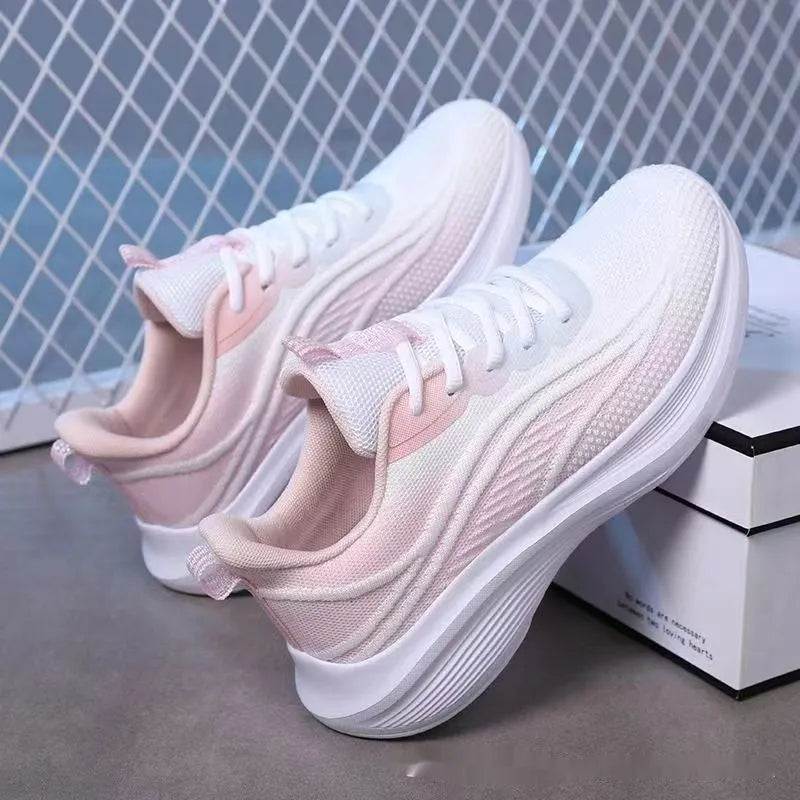 Women's low-top mesh running shoes in light pink with a round toe and front lace-up closure.