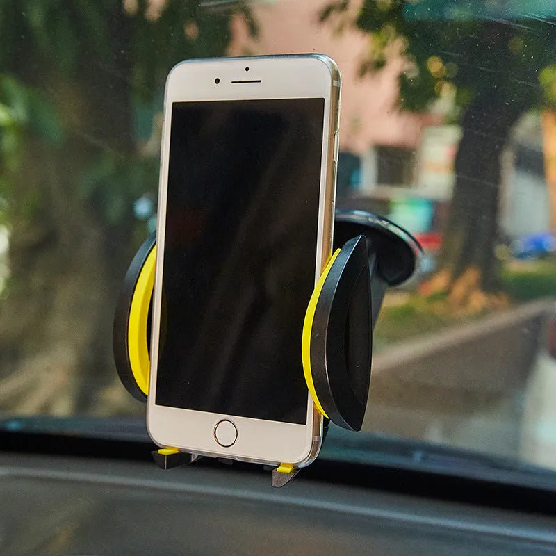 Red U-shaped suction cup phone holder mounted on a car windscreen, showing large clamp arm.