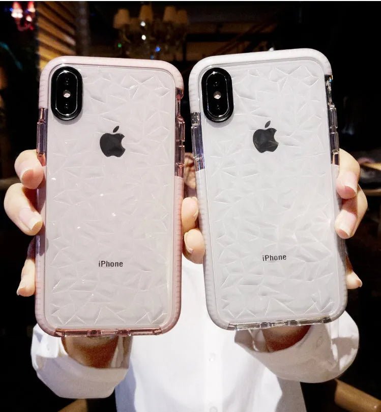 Striped TPU iPhone case shown in black, pink, and white edge colour options on a table.